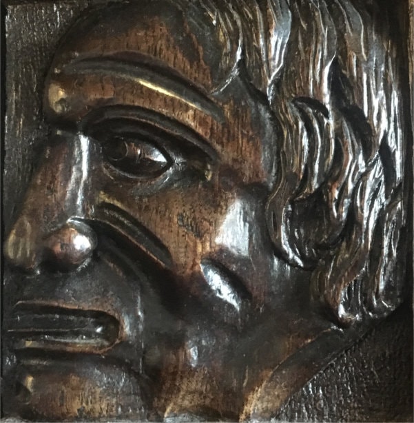 Carved man's head looking left
